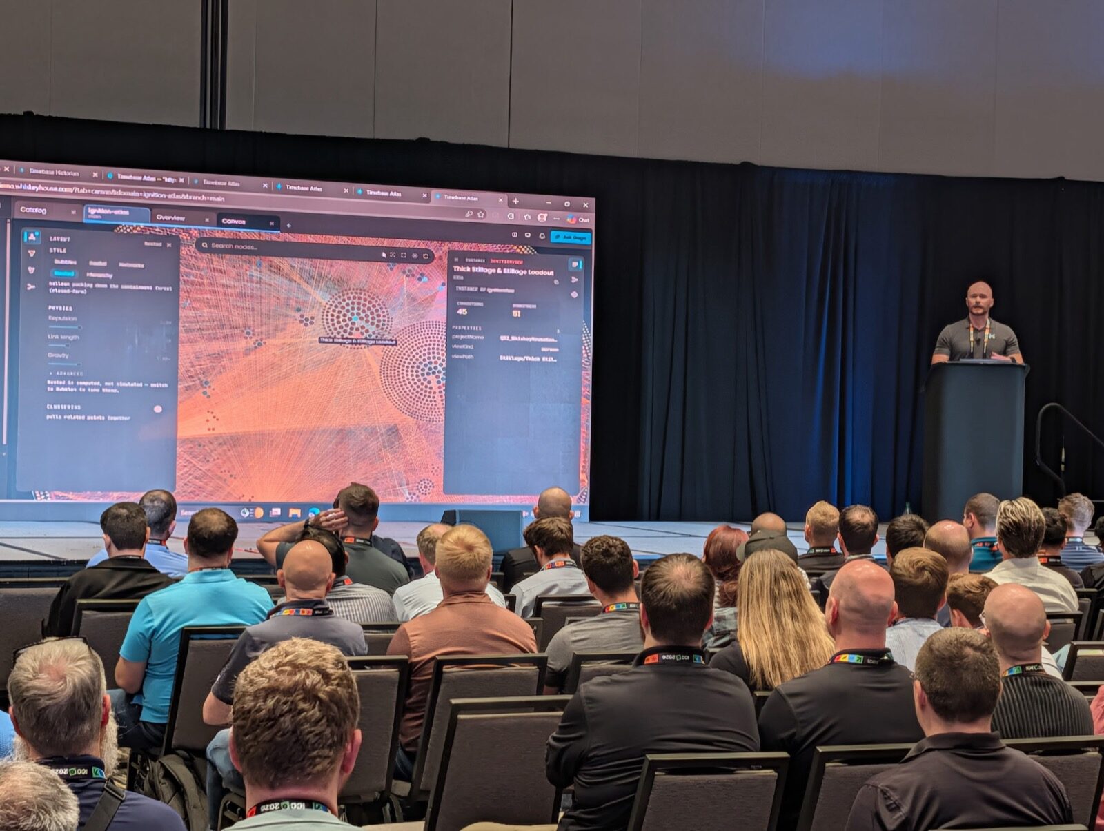 Patrick at the podium while a Timebase Atlas graph canvas of relationships fills the screen